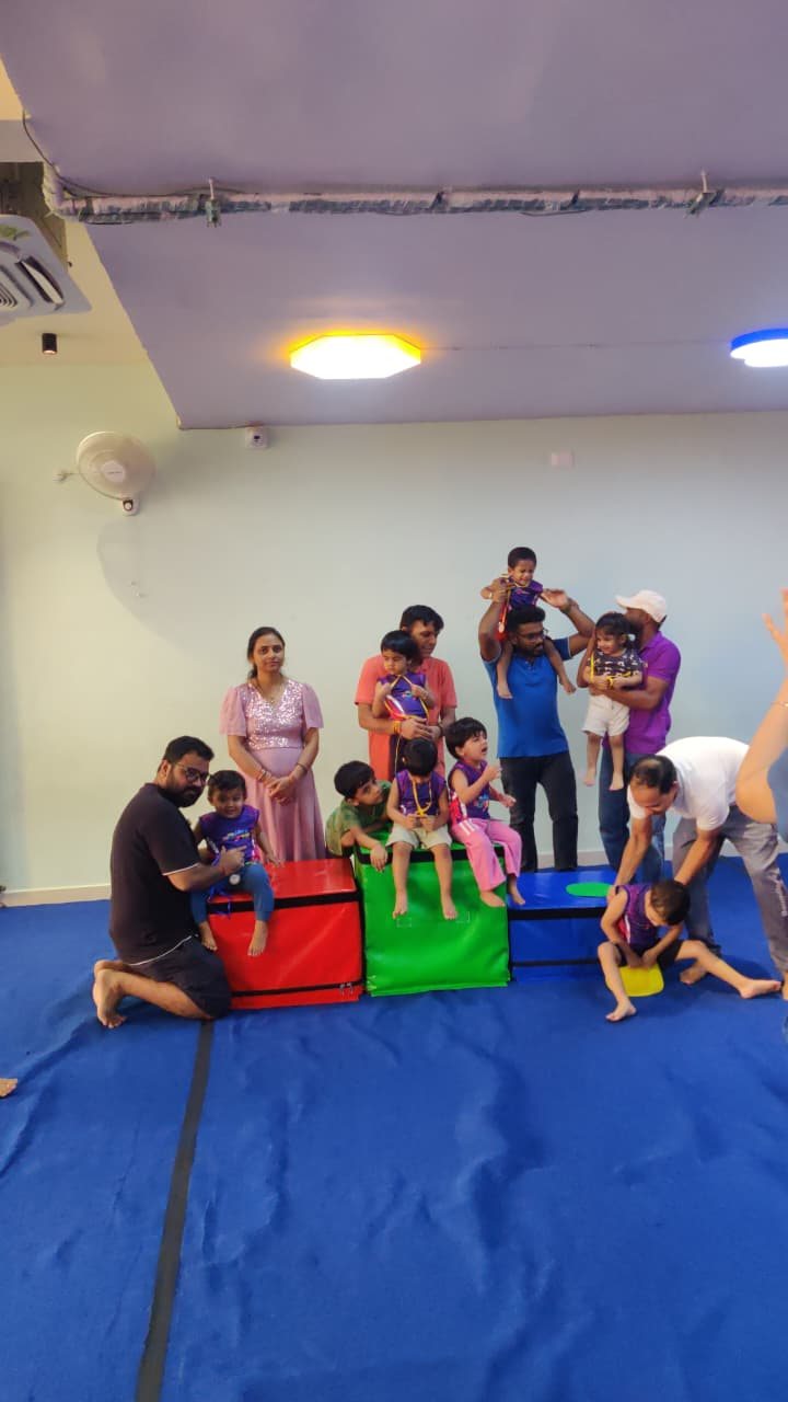 Children and adults gathering for a celebration at the gym