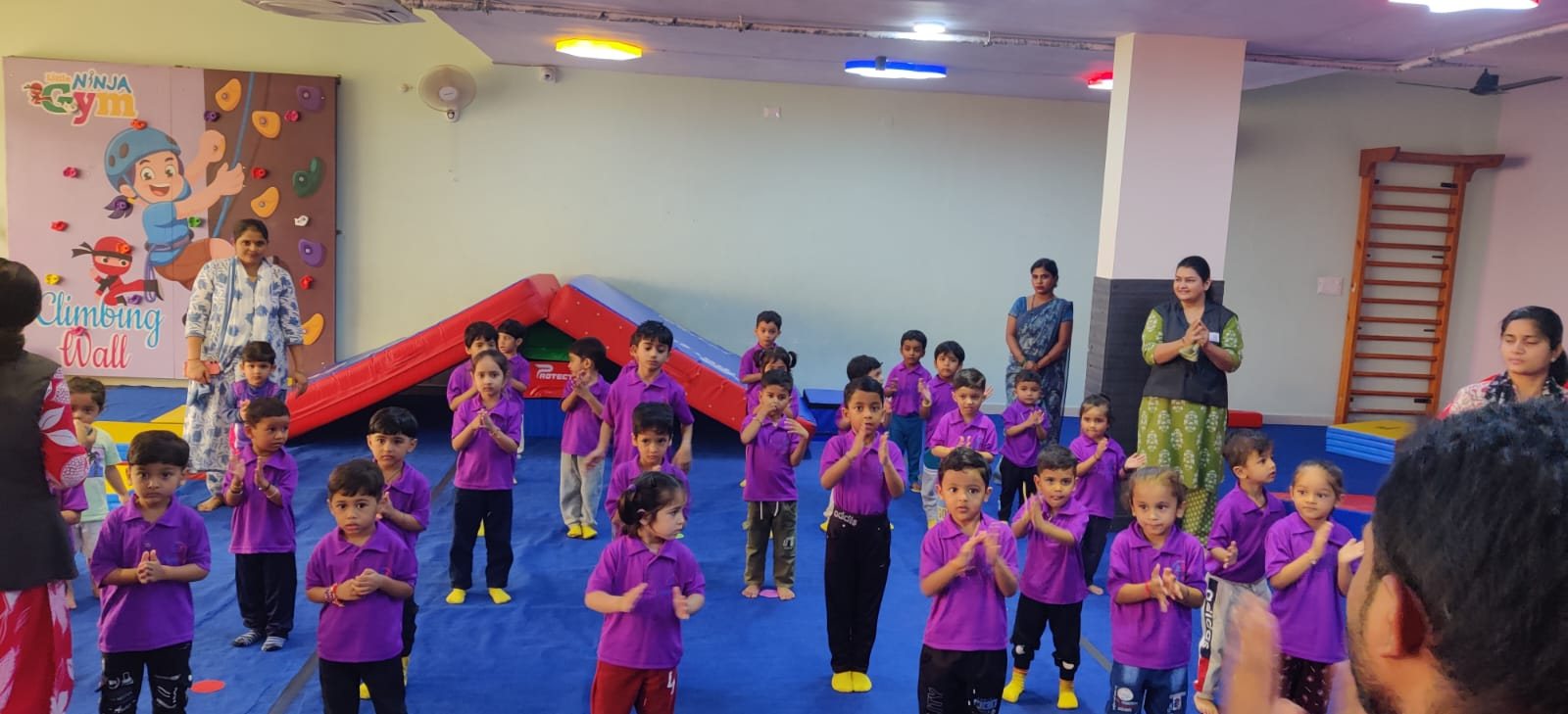 Children gathered together in the gym for a class activity