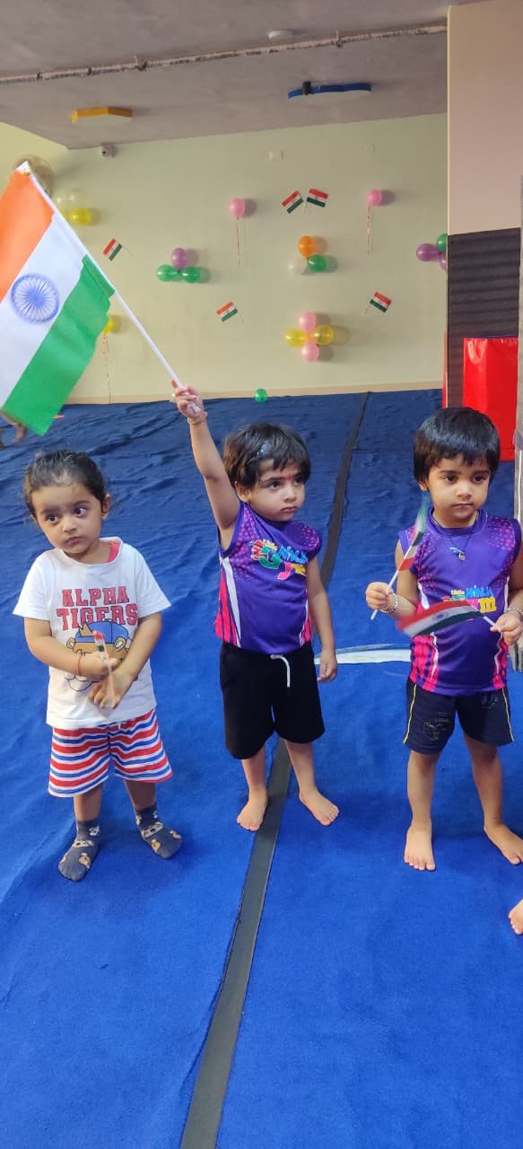 Children holding small flags during a gym activity