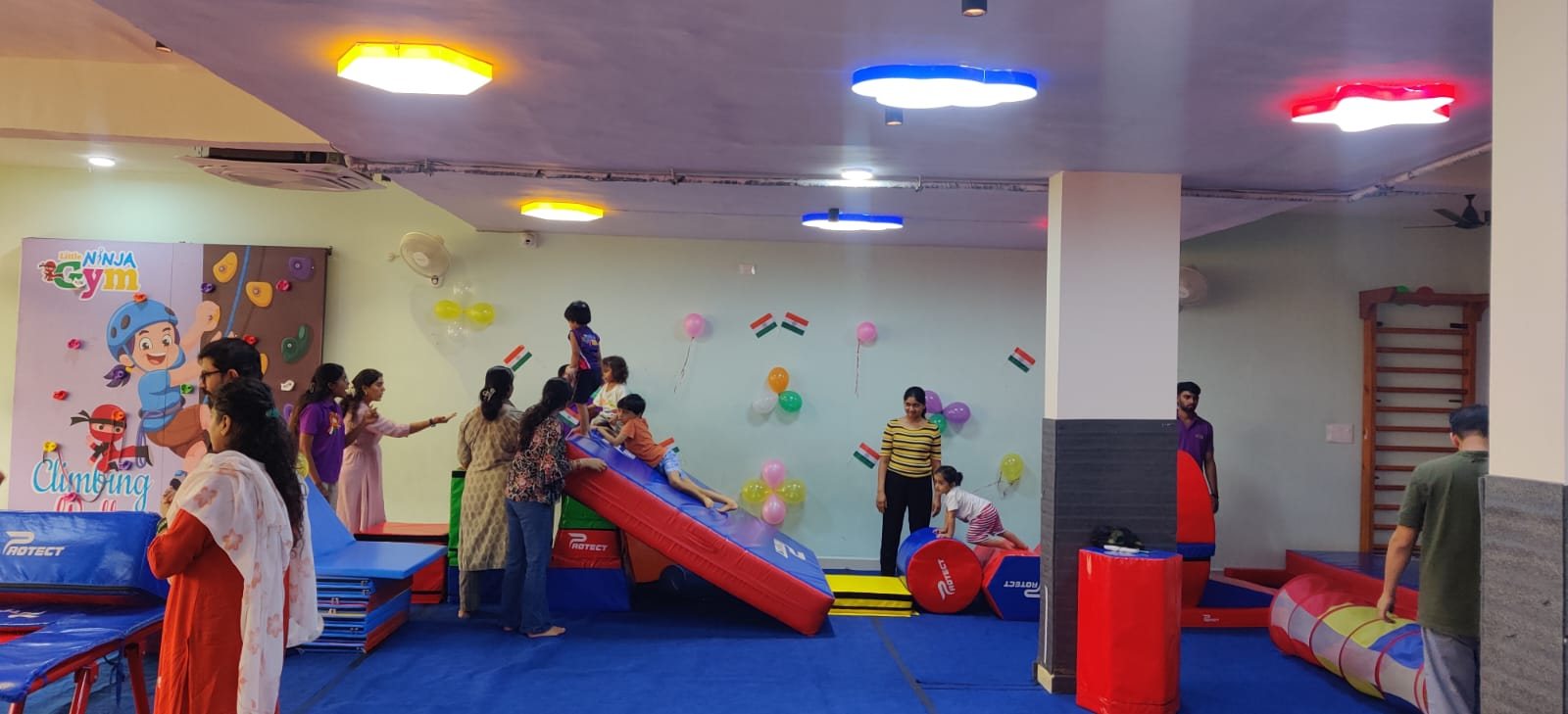 Child practising a gymnastic obstacle with a coach nearby