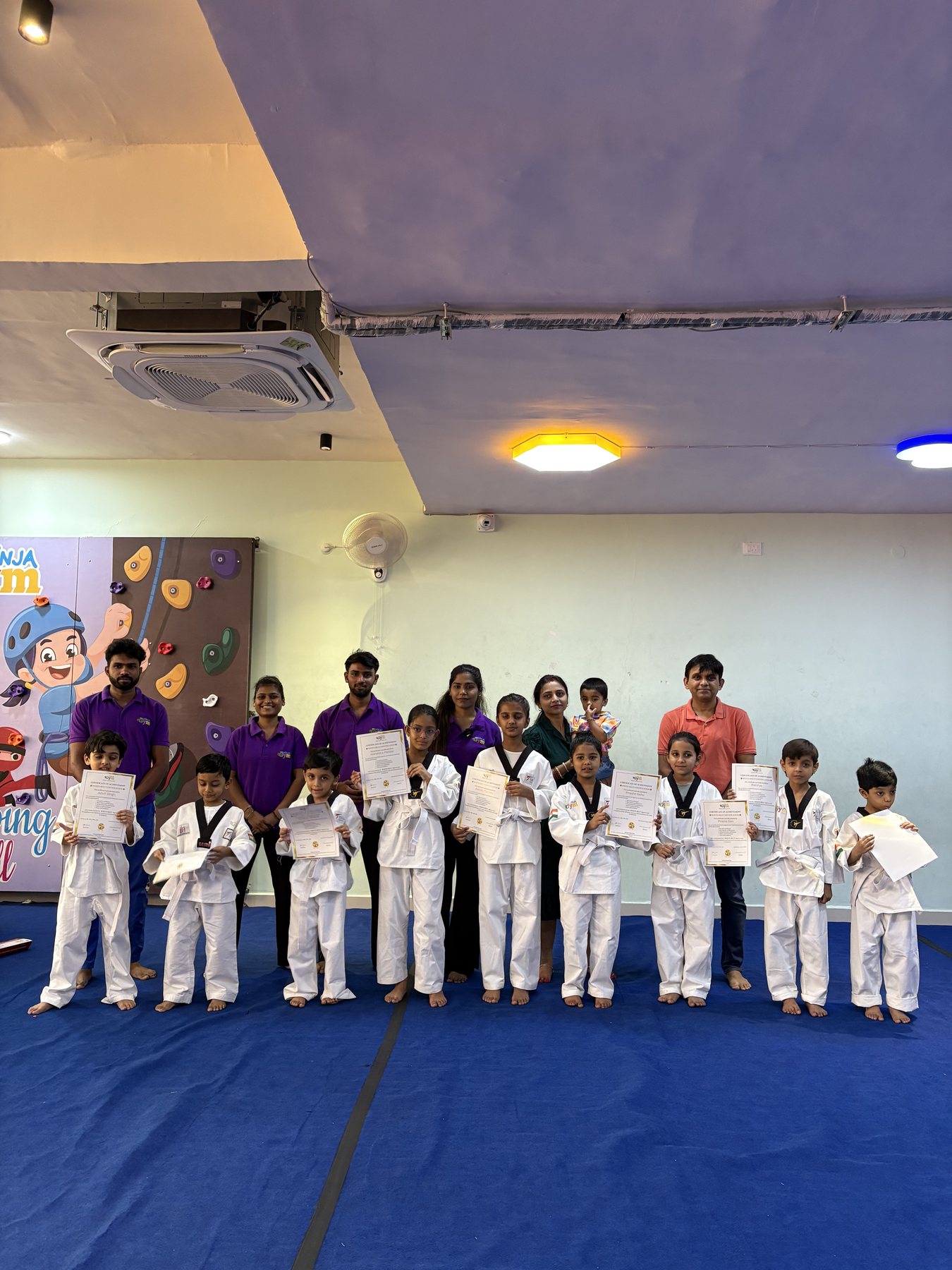 Children and instructors holding certificates at a Little Ninja Gym Taekwondo event