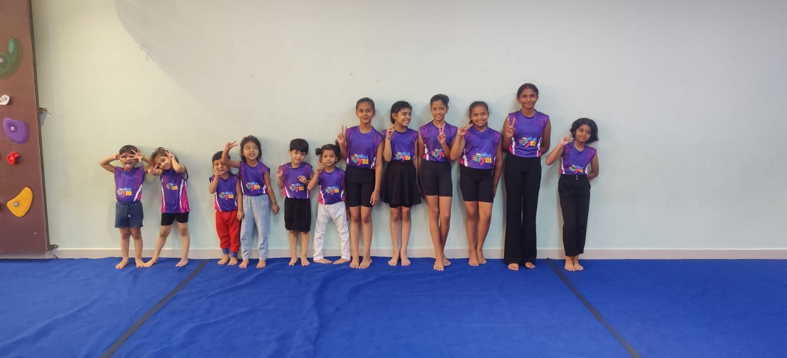 Little Ninja Gym team members standing together in purple uniforms